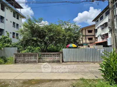 Charming residential area with lush greenery and clear blue skies