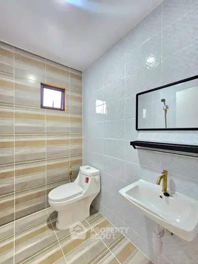 Modern bathroom with stylish tiles and sleek fixtures.
