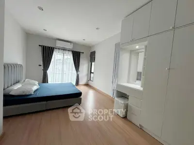 Spacious modern bedroom with elegant design and ample natural light