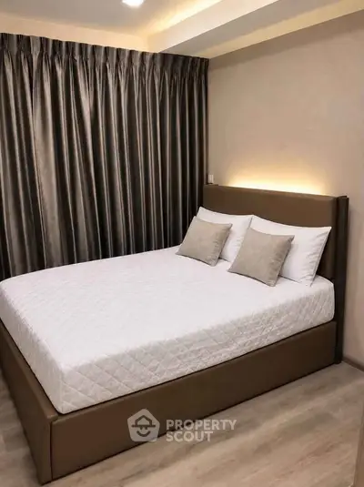 Modern bedroom with elegant curtains and cozy bed in stylish apartment.