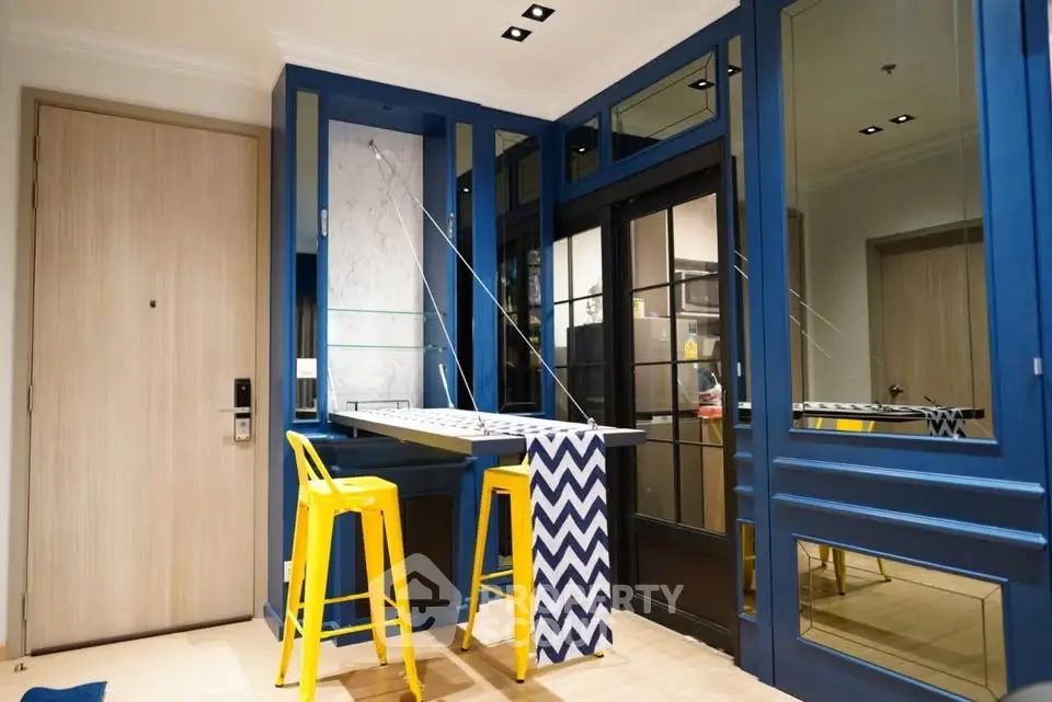 Stylish modern interior with vibrant blue accents and yellow bar stools, perfect for urban living.