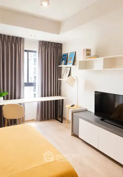 Modern bedroom with study area, featuring a sleek desk, cozy bed, and stylish decor in a bright, airy space.