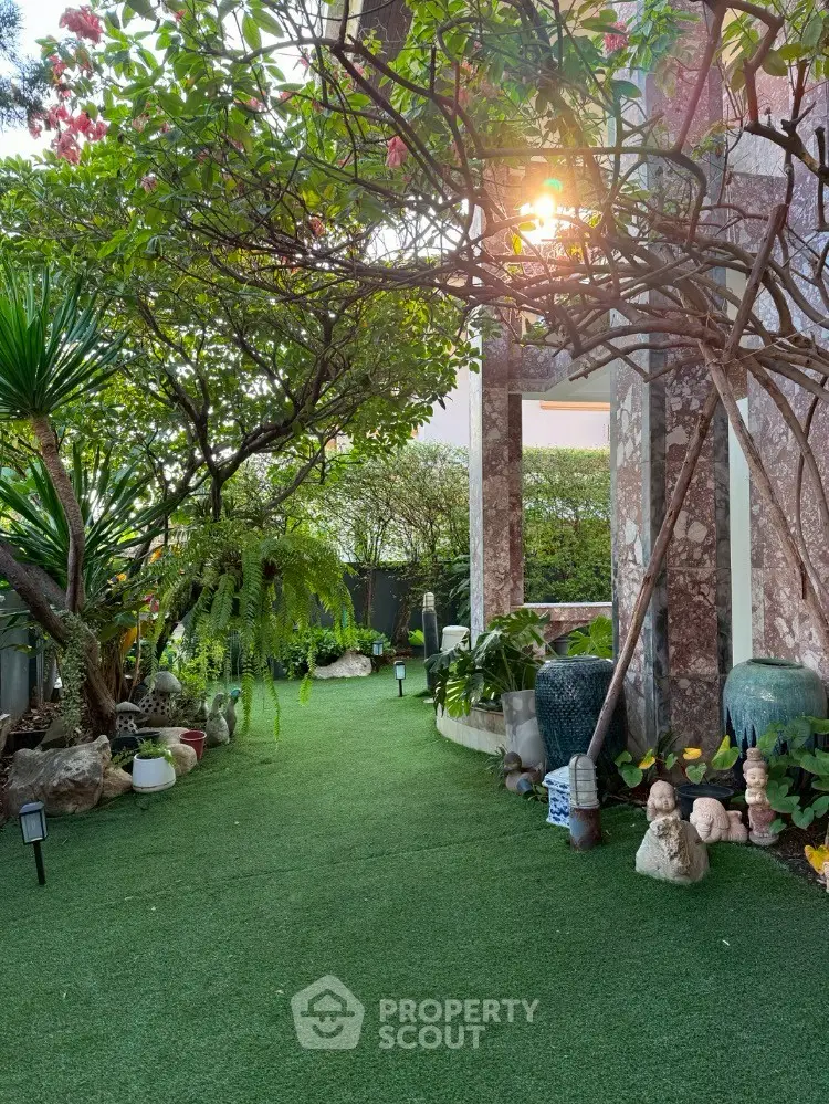 Charming garden with lush greenery and stone pathway, perfect for tranquil outdoor living.