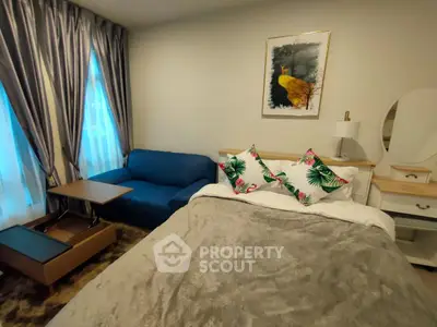 Cozy bedroom with stylish decor, featuring a comfortable bed, elegant curtains, and a chic sofa.