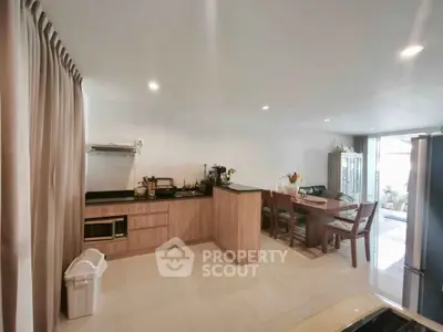 Spacious open-layout kitchen with dining area and modern appliances.