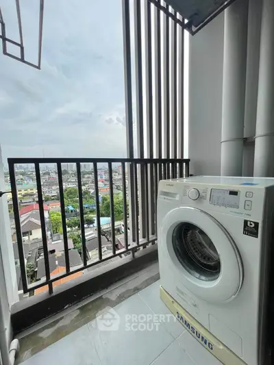 High-rise balcony with washing machine and city view, perfect for urban living convenience.