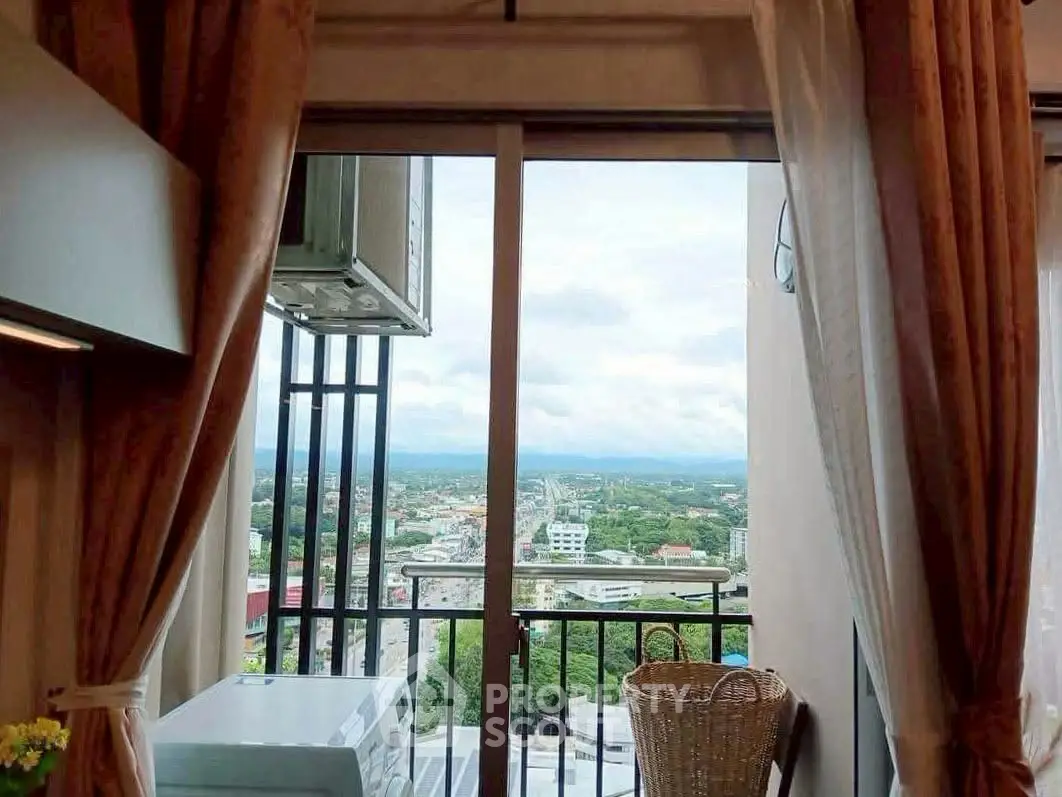 Stunning high-rise apartment with breathtaking city view from the balcony, featuring elegant curtains and modern decor.