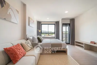 Spacious modern bedroom with large window and scenic view, featuring cozy sofa and stylish decor.