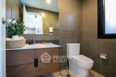 Modern bathroom with sleek design, featuring a stylish vanity and contemporary fixtures.
