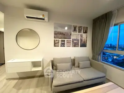 Modern living room with city view, stylish decor, and comfortable seating.