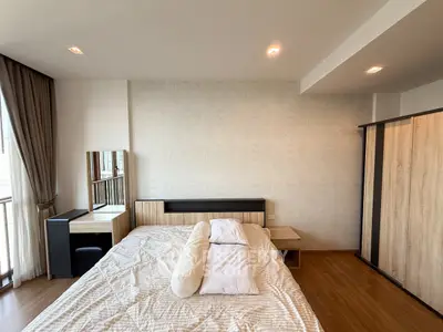 Spacious modern bedroom with stylish decor and natural light