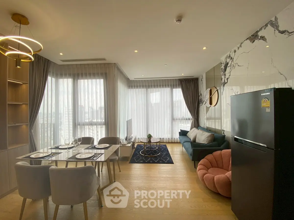 Modern living room with elegant decor and large windows offering city views