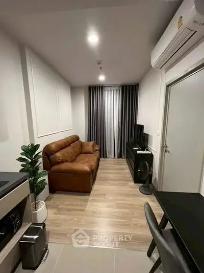 Modern living room with brown leather sofa and sleek decor