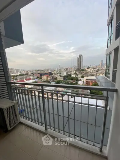 Spacious balcony with stunning city view in modern high-rise apartment