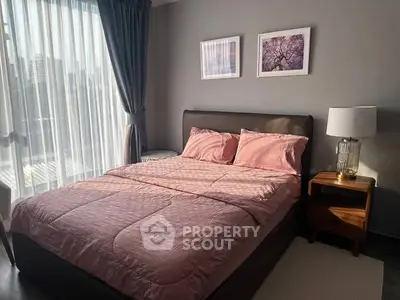 Cozy bedroom with stylish decor and natural light in modern apartment.