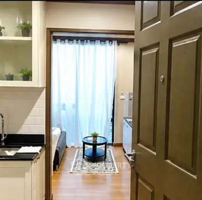 Charming apartment entrance with cozy living area and modern kitchen