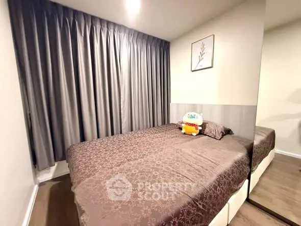 Cozy bedroom with elegant curtains and plush bedding in modern apartment