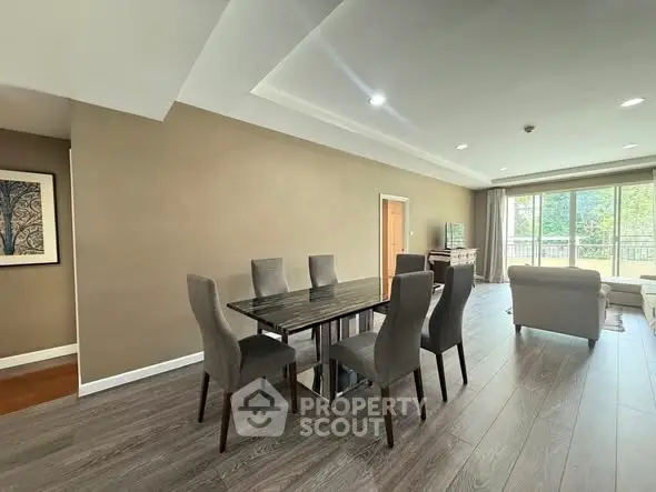 Spacious modern living room with elegant dining area and large windows.