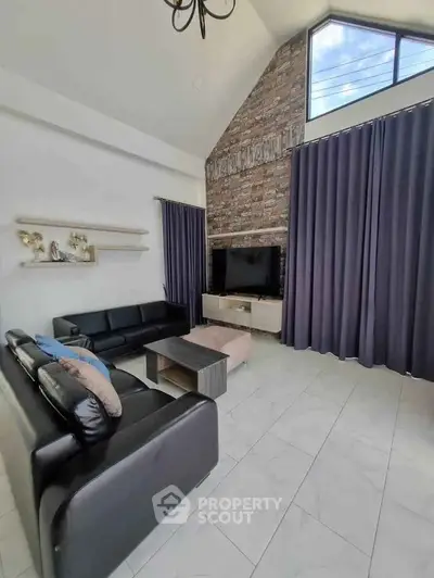 Spacious modern living room with high ceiling and large windows