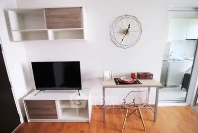 Modern living room with sleek TV setup and stylish dining area