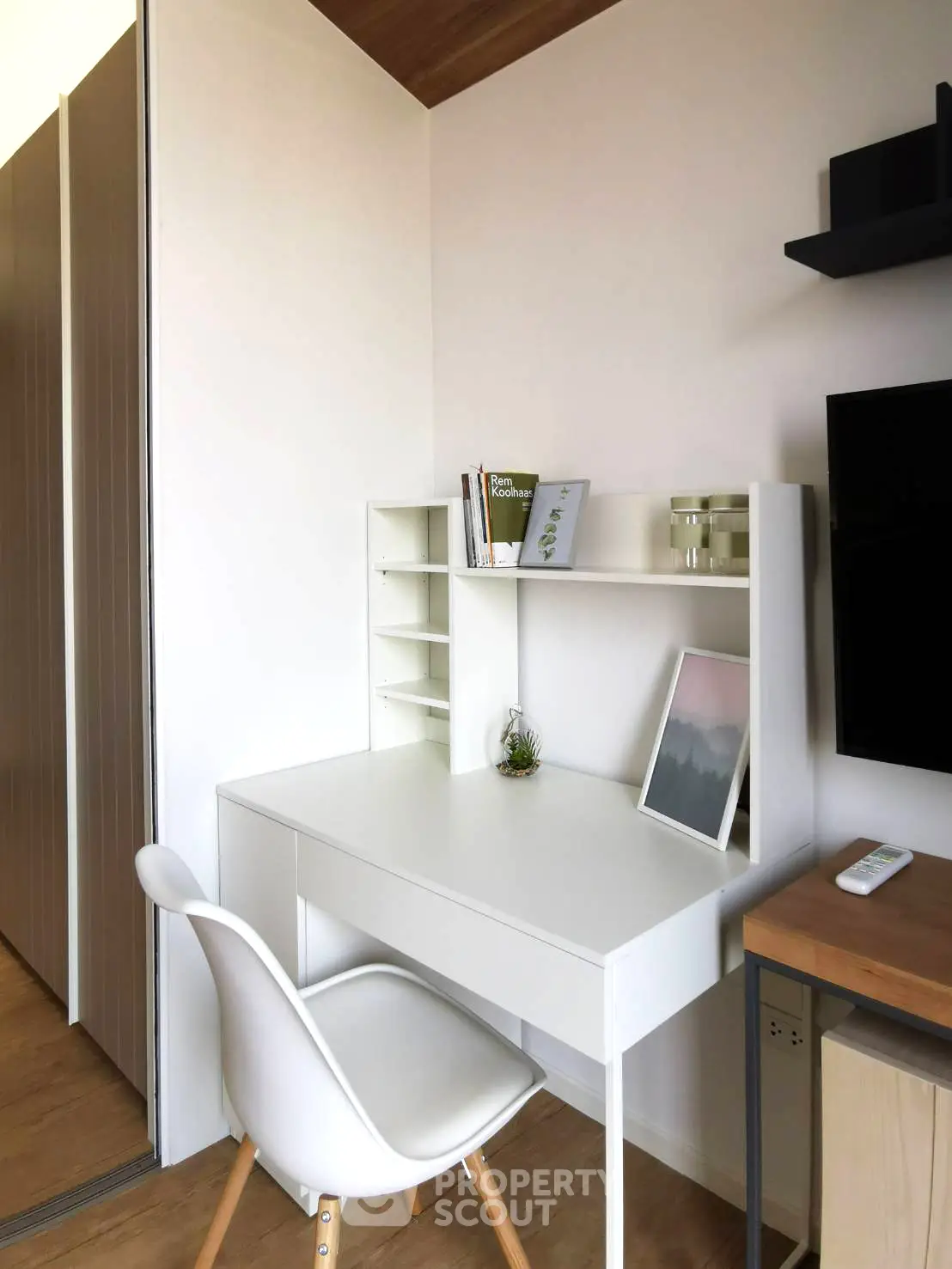 Modern study area with sleek white desk and chair, perfect for productivity.