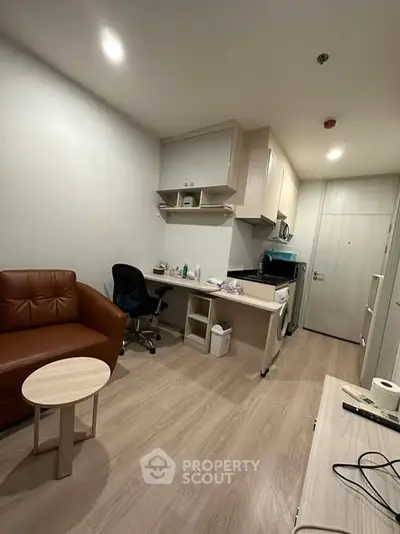 Modern studio apartment with cozy living area and compact kitchen