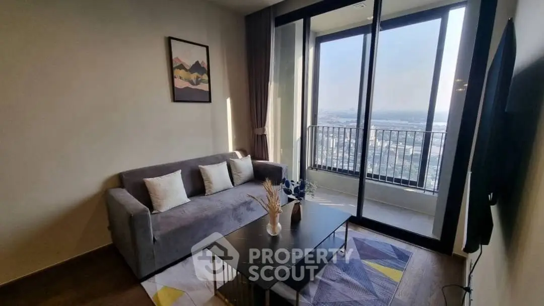 Modern living room with balcony and scenic view, featuring a cozy sofa and stylish decor.