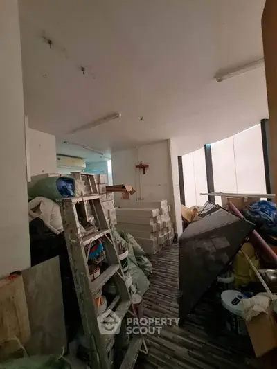 Spacious storage room with construction materials and tools, ideal for renovation projects.