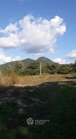 Scenic land plot with mountain views and lush greenery, perfect for development or investment.