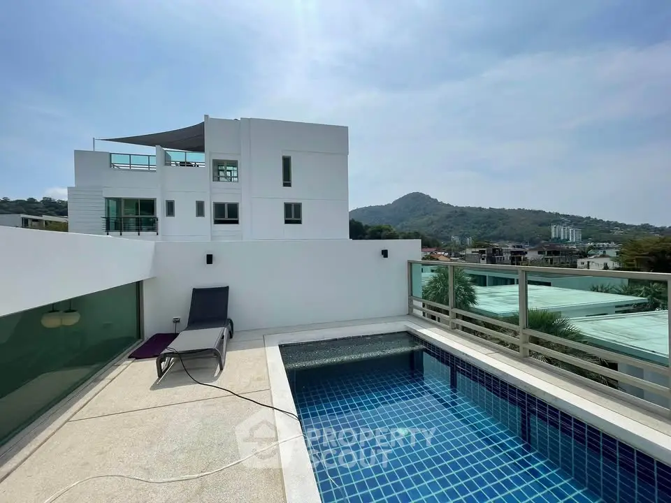 Luxurious rooftop pool with stunning mountain views in modern residential building.