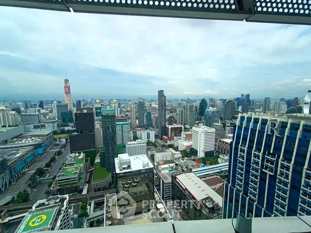 Stunning cityscape view from a high-rise building balcony, showcasing urban skyline and modern architecture.