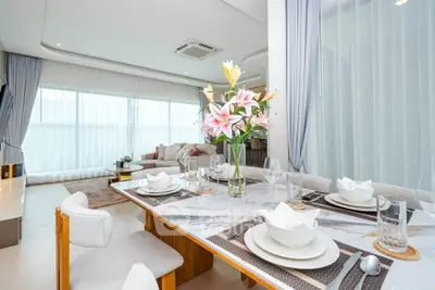 Luxurious open-plan living and dining area with elegant decor and natural light.