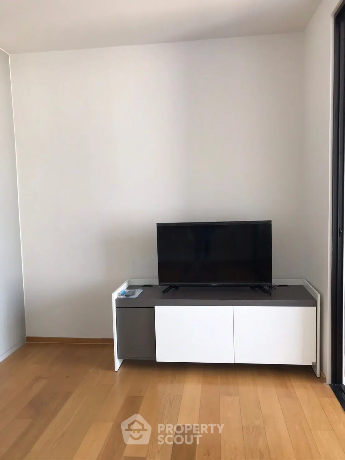 Modern living room with sleek TV stand and wooden flooring