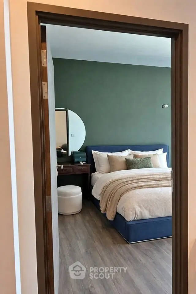 Stylish bedroom with modern decor and cozy bedding in a contemporary apartment.