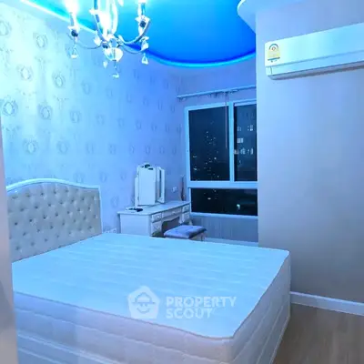 Elegant bedroom with modern lighting and city view, featuring a plush bed and stylish decor.