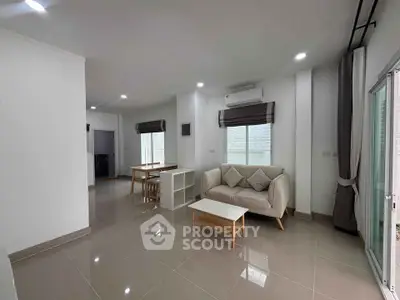 Spacious modern living room with sleek furniture and natural light