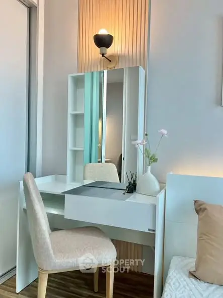 Elegant bedroom corner with modern vanity and soft lighting, perfect for a serene start to your day.
