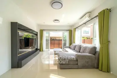 Spacious living room with modern decor and large windows for natural light