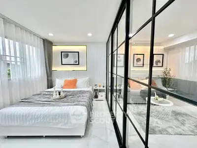 Modern bedroom with glass partition and stylish decor
