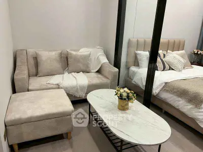 Cozy modern bedroom with elegant decor and comfortable seating area.