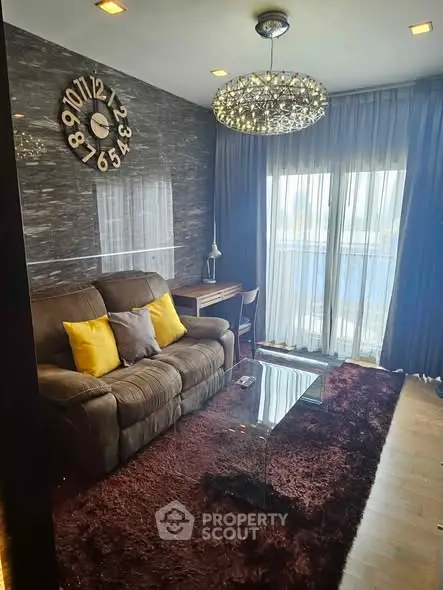 Luxurious living room with plush sofa, elegant chandelier, and modern decor