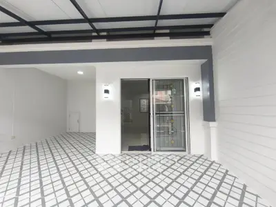 Modern home entrance with stylish geometric flooring and sleek lighting