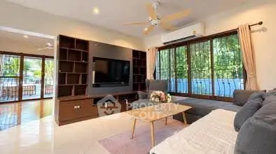Spacious living room with modern decor and large windows offering natural light.