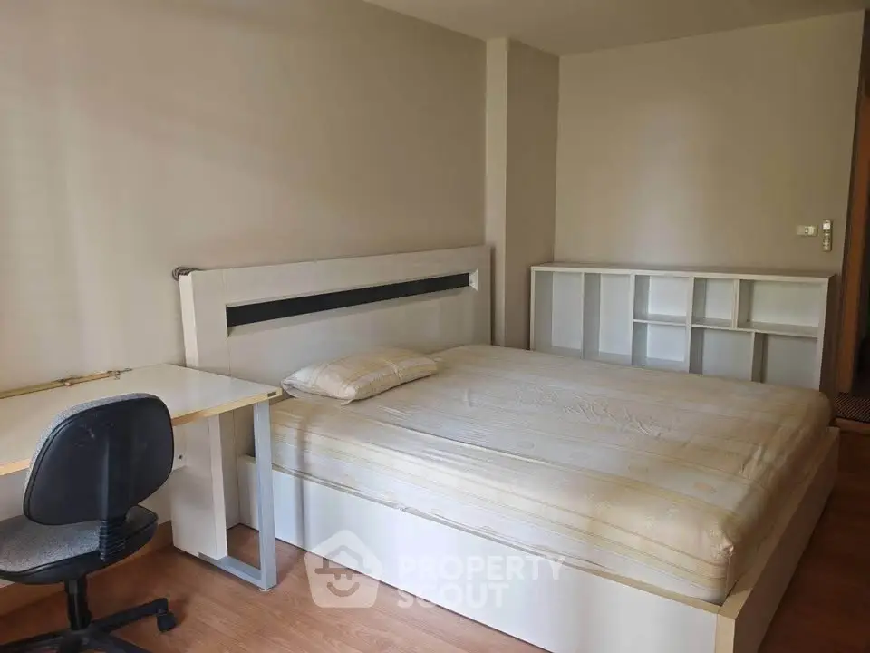 Spacious bedroom with modern furniture and ample natural light