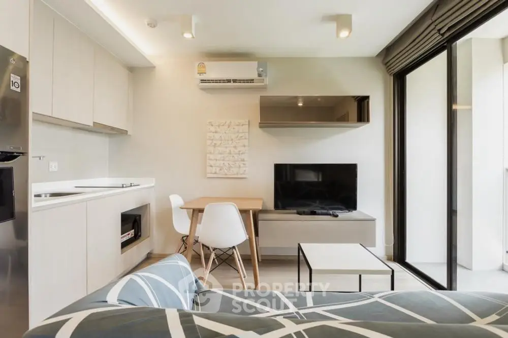 Modern living room with sleek furniture and large windows for natural light.