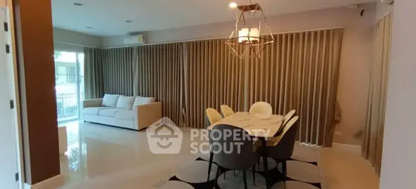 Spacious living room with elegant dining area and modern lighting