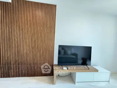 Modern living room with wooden accent wall and sleek TV stand