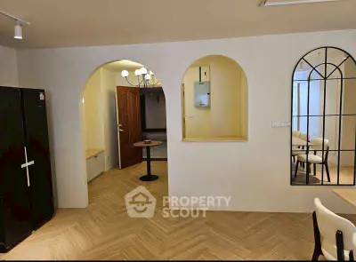 Chic modern interior with arched doorways and elegant dining area, perfect for stylish living.
