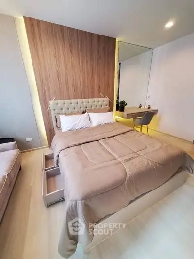 Modern bedroom with stylish decor and built-in storage, featuring a cozy bed and elegant furnishings.