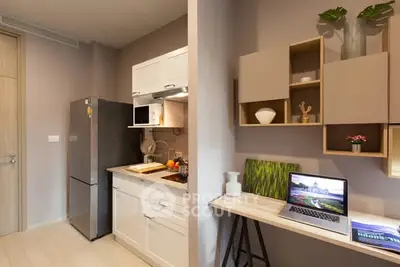 Modern kitchen with sleek design and workspace, featuring stainless steel fridge and stylish shelving.